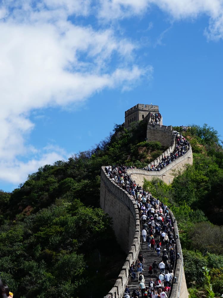 Aerial view of Badaling Great Wall winding through lush green mountains in Beijing, China