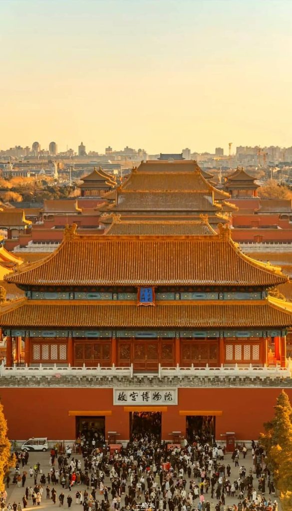 Aerial view of the Forbidden City in Beijing, showing traditional golden roofs and red walls