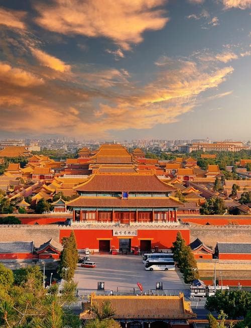 The iconic Meridian Gate (Wumen) of Beijing's Forbidden City with 'The Palace Museum' sign in Chinese and English, the main entrance to the imperial palace complex